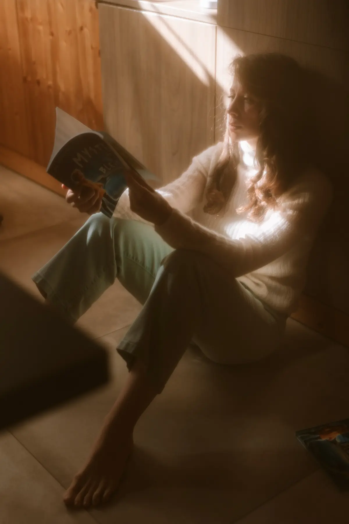 Joy Bondielli reading in warm natural light