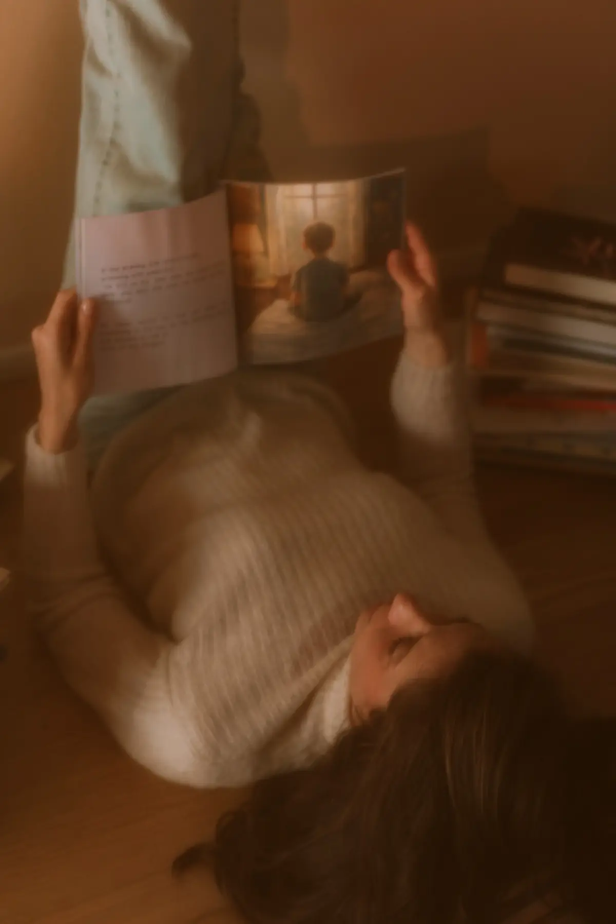 Joy reading beside a stack of children's books
